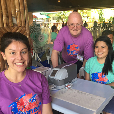 Lena Rennick & Neil Donelan pictured with the Point of Care (portable) system as part of humanitarian aid by the Fiona Kwok Diabetes Screening Program of Insulin for Life in a youth diabetes camp in the Philippines.